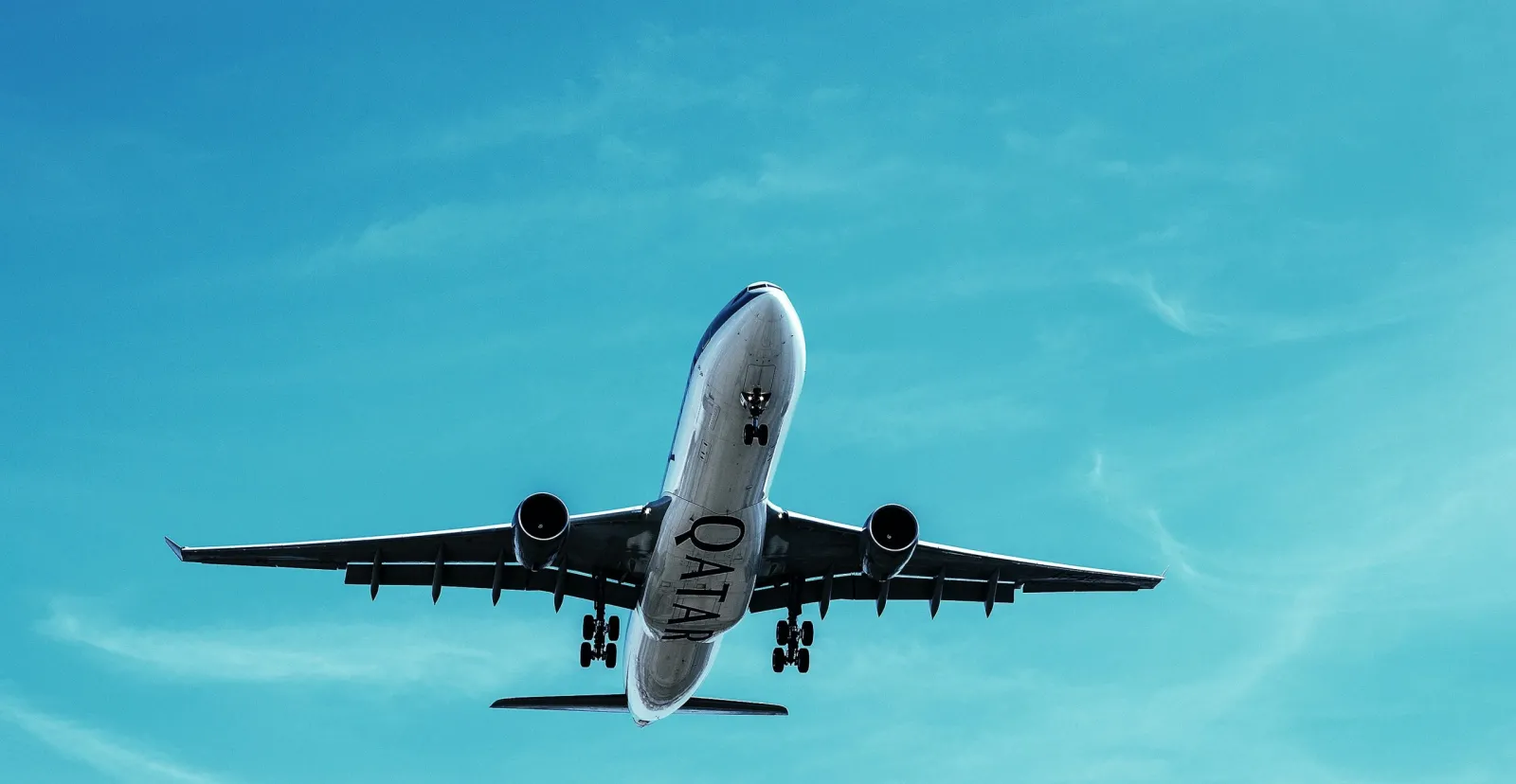 A passenger jet flying against a clear blue sky